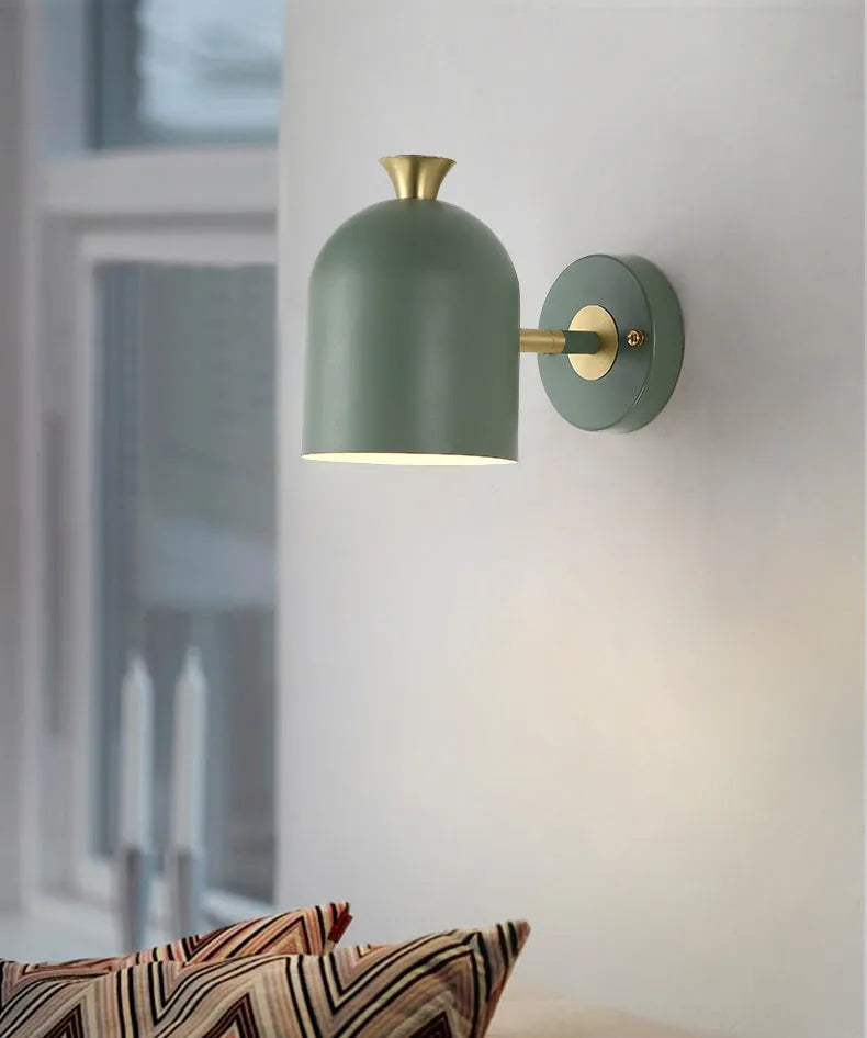 Blue aluminium single-head LED wall lamp mounted beside a bed.