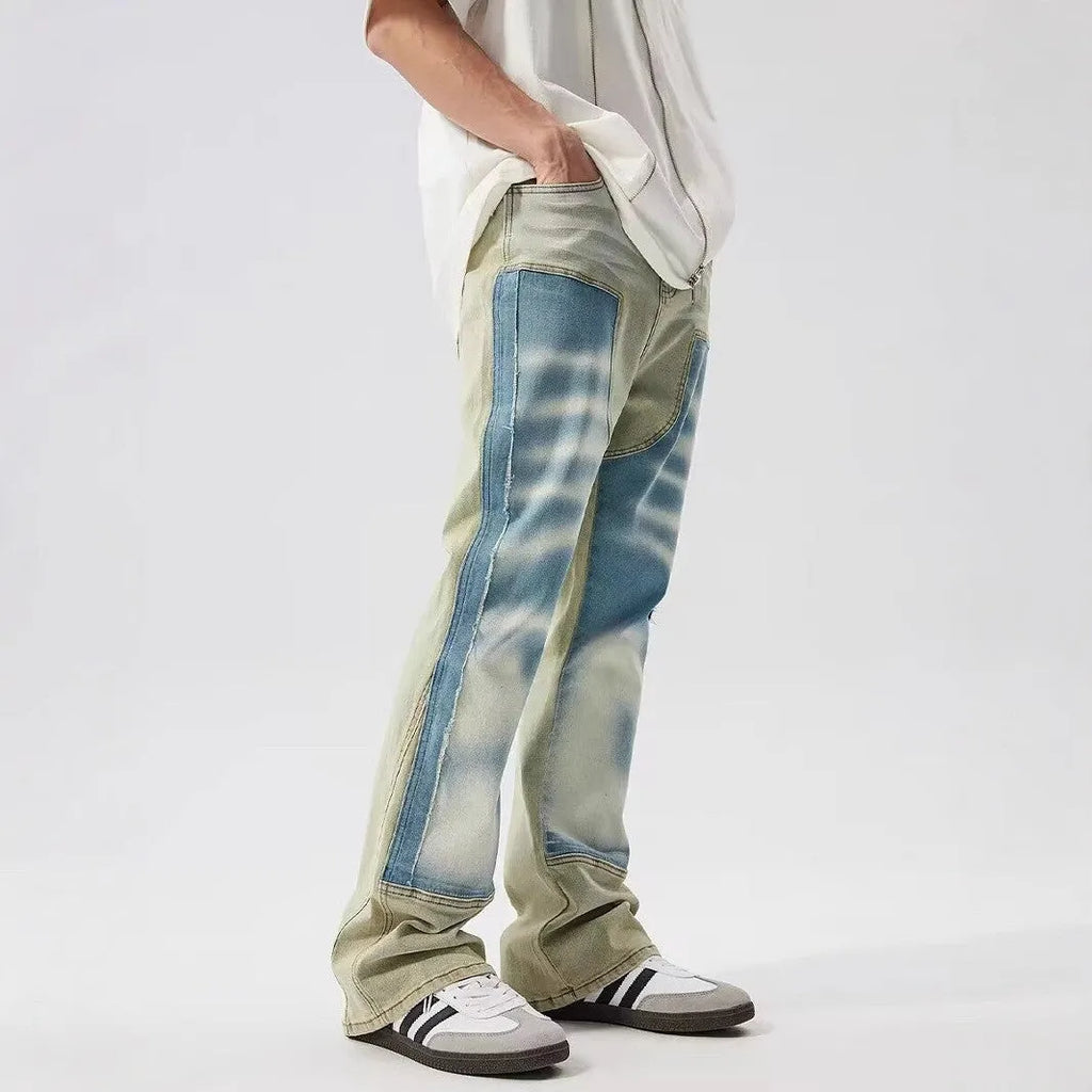 Retro yellow and blue patchwork jeans with splash-ink damaged design showing front and back views