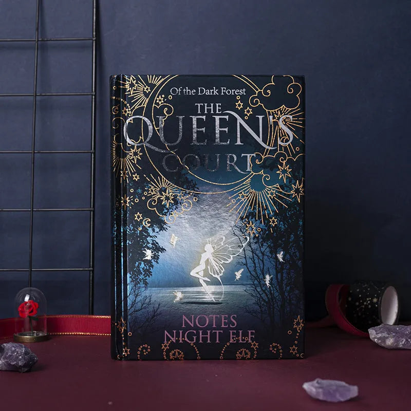 Blue A5 hardcover notebook with glowing night elves illustration, open to show colourful internal pages.