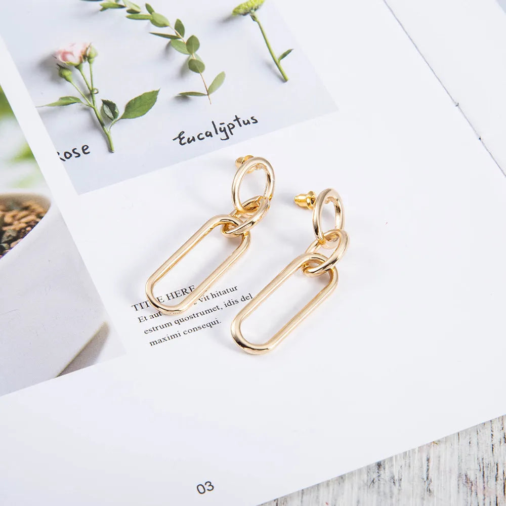 Geometric sterling silver needle hoop earrings with ring and line design in alloy metal
