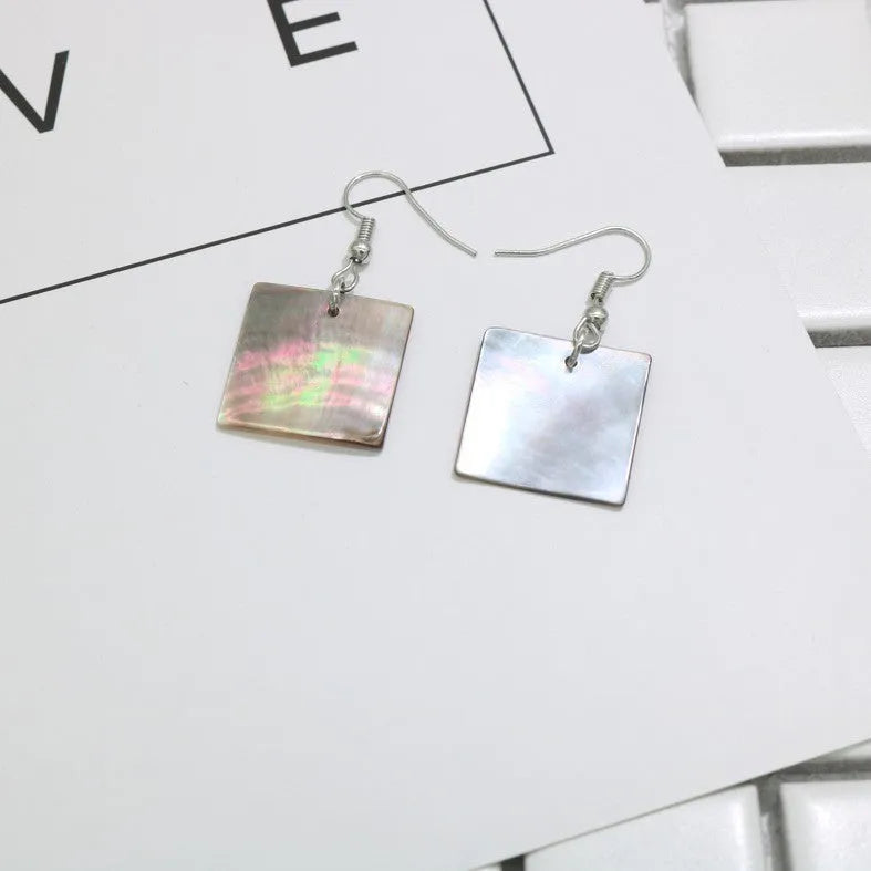 Women's geometric shell earrings in square panther or rectangular shell designs with natural material texture