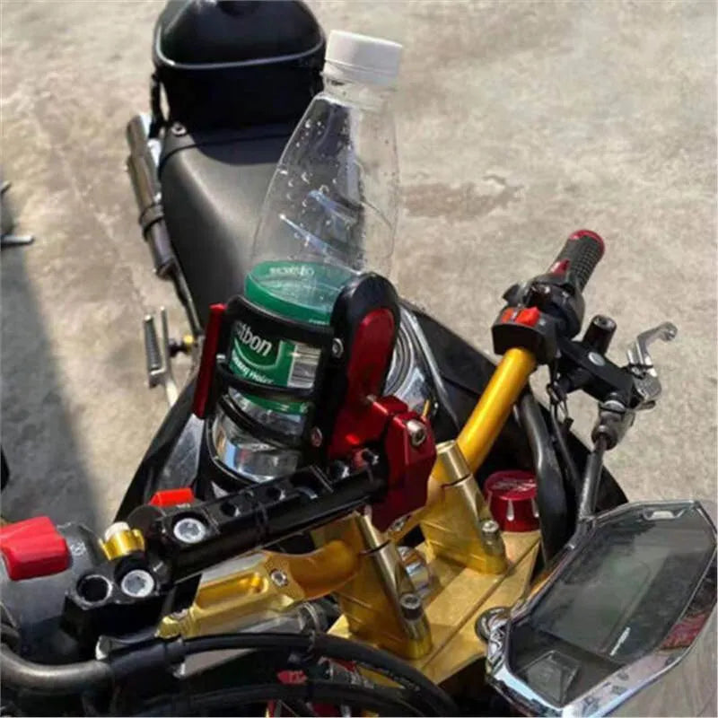 Metal alloy water bottle cage mounted to Honda X-ADV scooter pedal in black finish