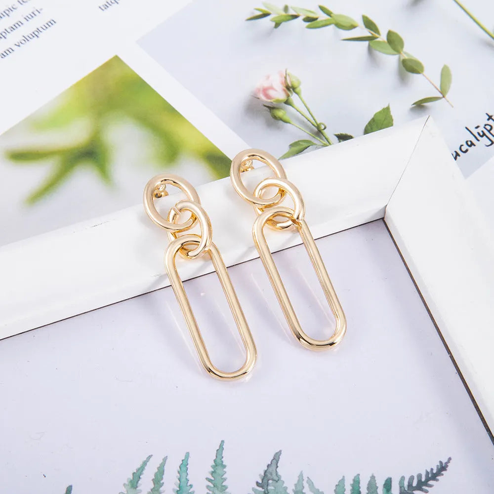 Geometric sterling silver needle hoop earrings with ring and line design in alloy metal