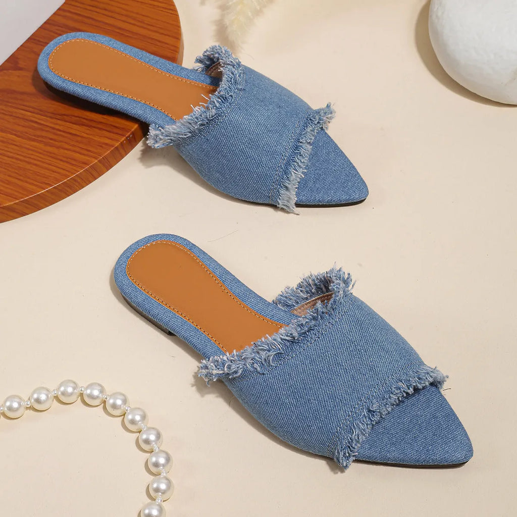 Women's denim flat slippers with tassel detail in multiple colour options showing leather lining and PVC sole