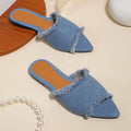 Women's denim flat slippers with tassel detail in multiple colour options showing leather lining and PVC sole