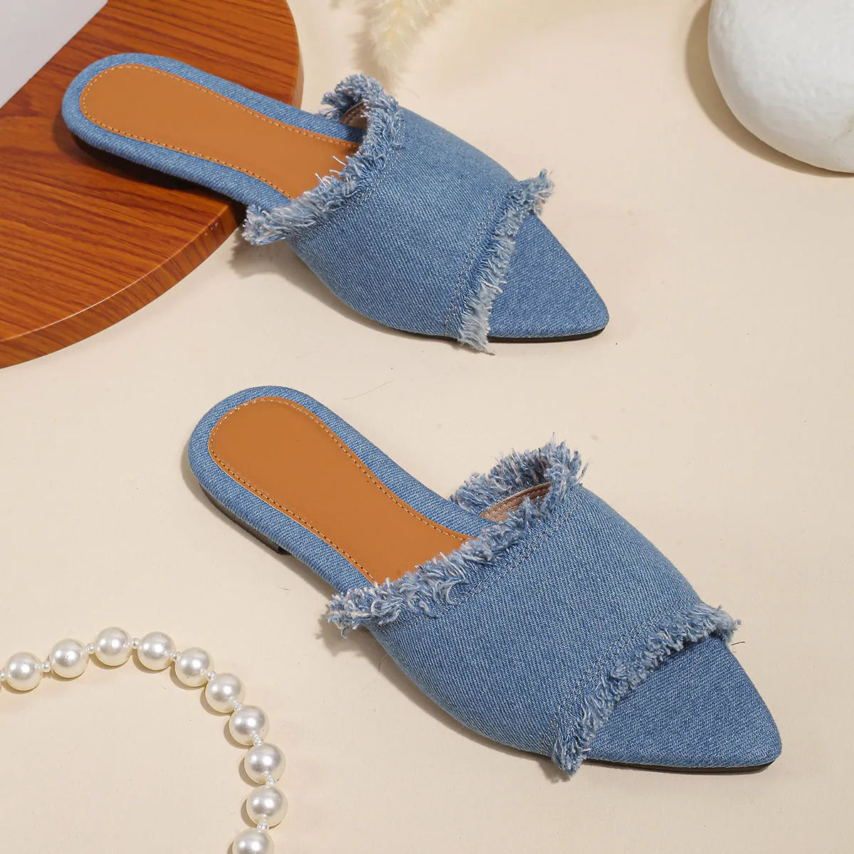 Women's denim flat slippers with tassel detail in multiple colour options showing leather lining and PVC sole