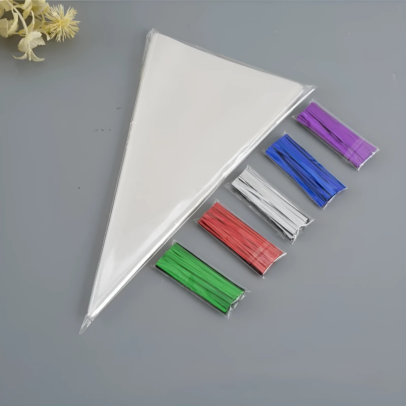 Clear triangle-shaped plastic packaging bag with a silver tie wire closure, shown in three different sizes.