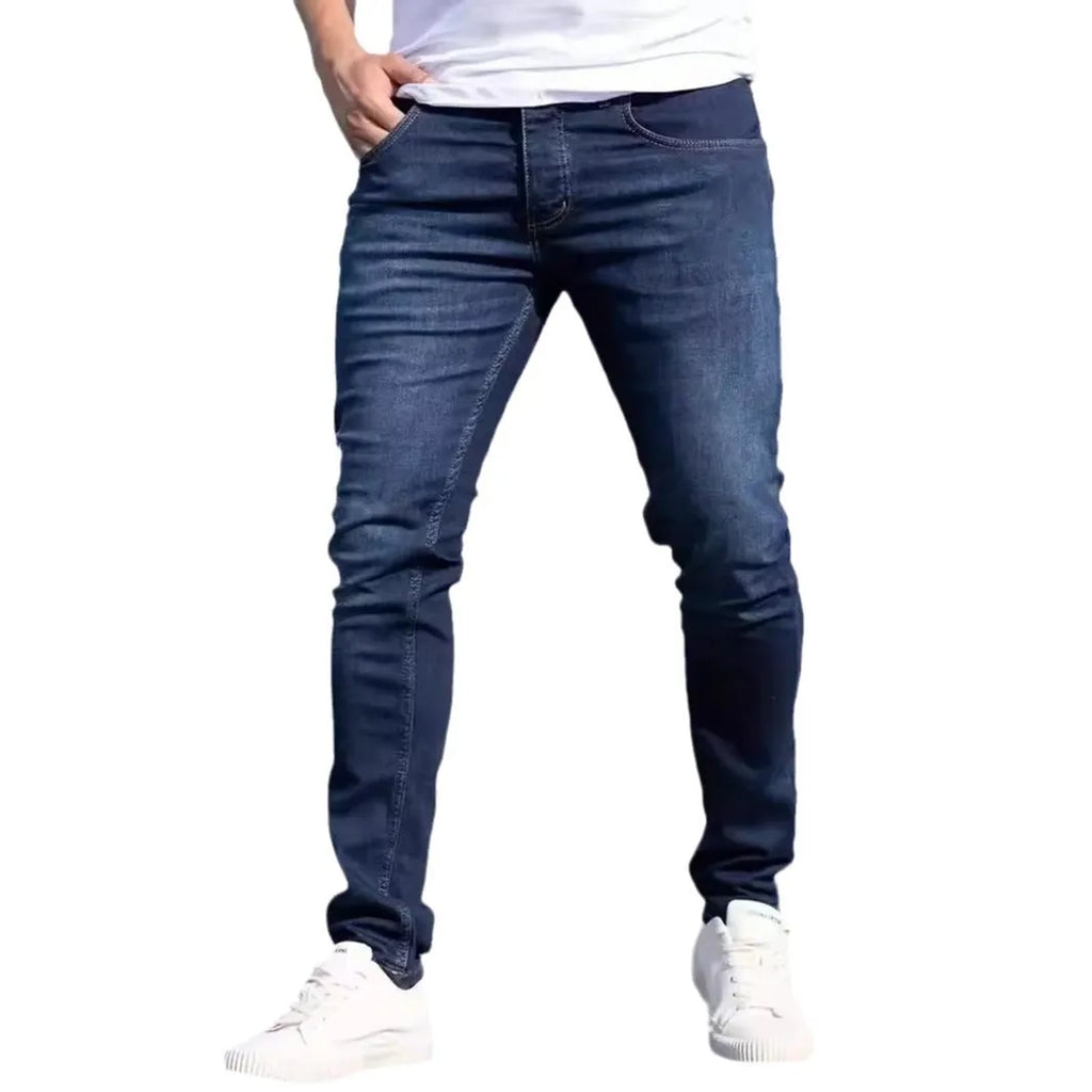 Men's dark blue slim fit jeans with skinny leg design and mid waist cut