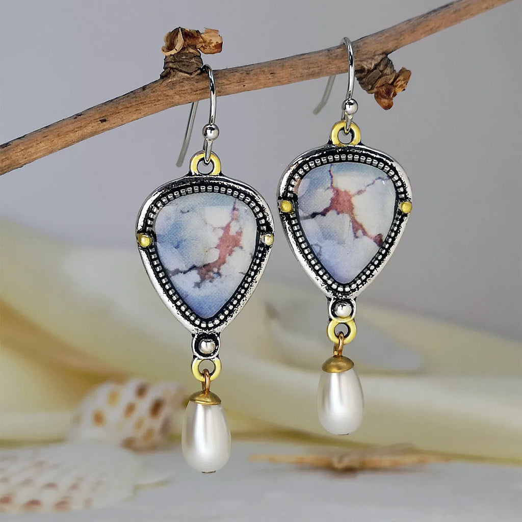 Retro blue geometric drop earrings with synthetic opal and pearl details on a two-tone electroplated metal setting.