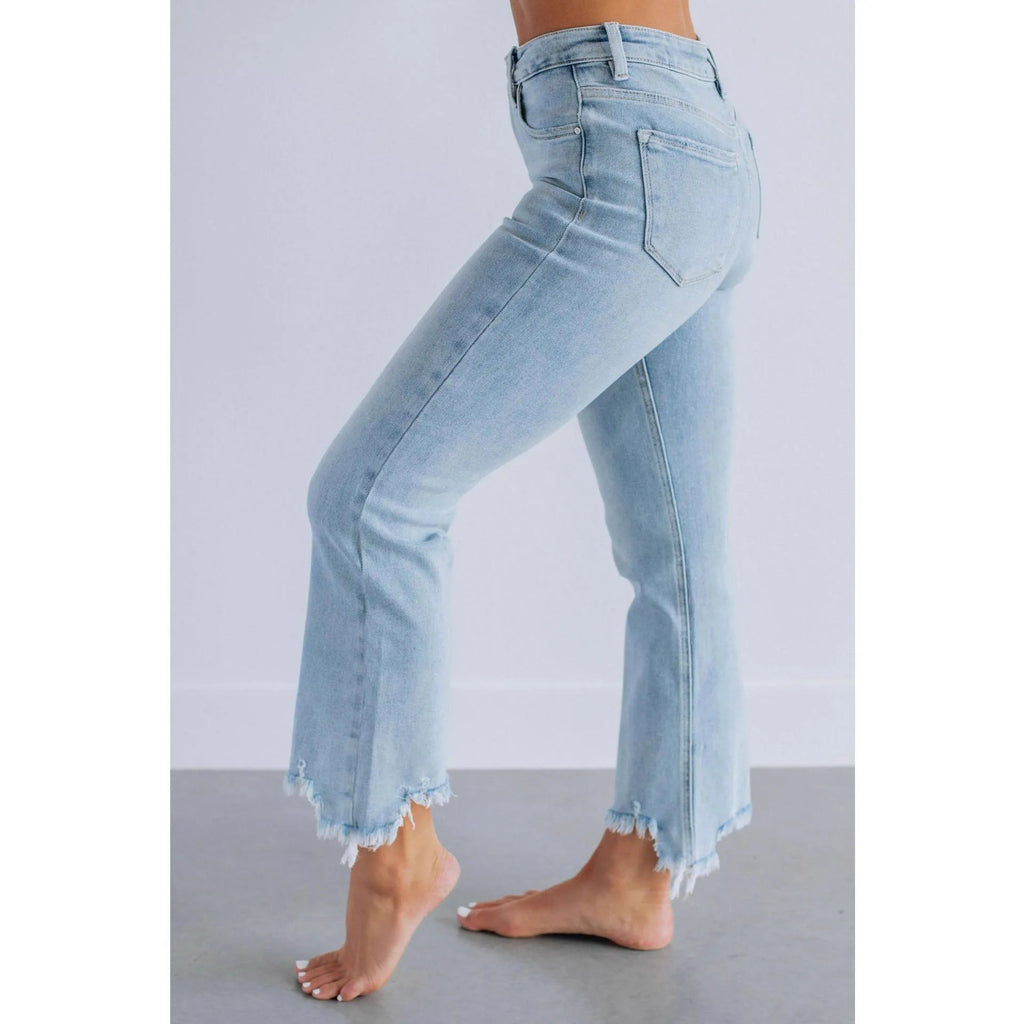 Women's solid colour denim jeans on a hanger showing hand-worn texture and available in dark blue and light blue