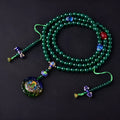 Natural green agate 108-bead bracelet with pendant in Thangka style on a wrist.