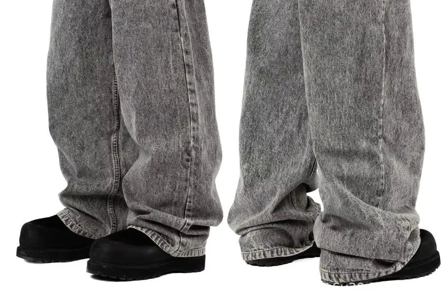 Grey loose-fitting straight-leg cotton denim trousers for men and women on a hanger