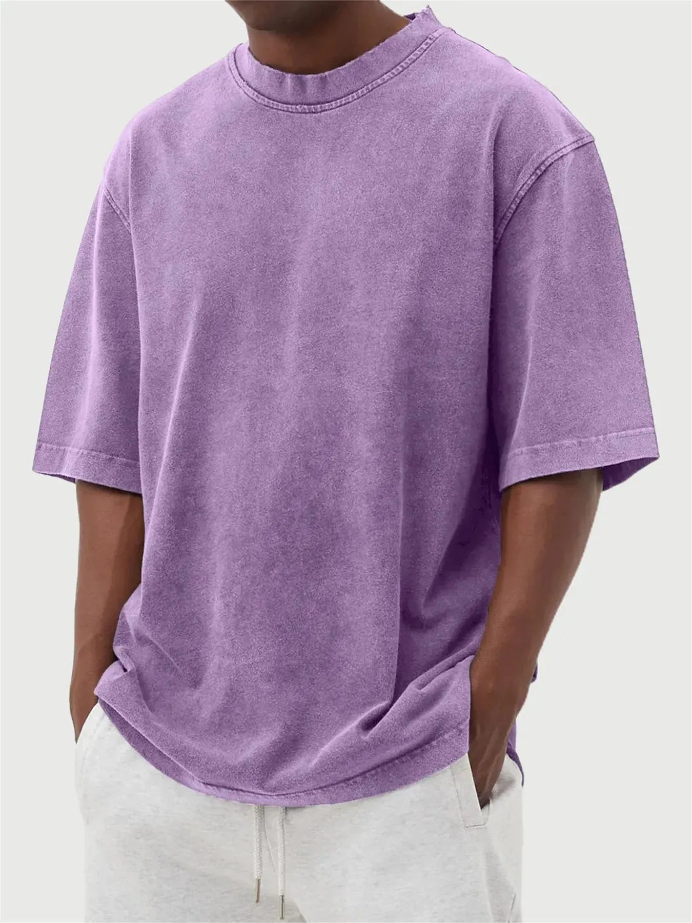 Men's loose fit pullover T-shirt in a stone-washed distressed solid colour, shown in army green.