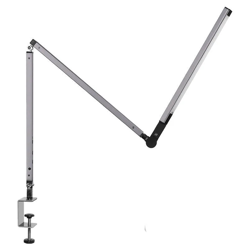 Folding aluminium desk lamp with a metal clip, shown in dazzling black, attached to a desk edge.