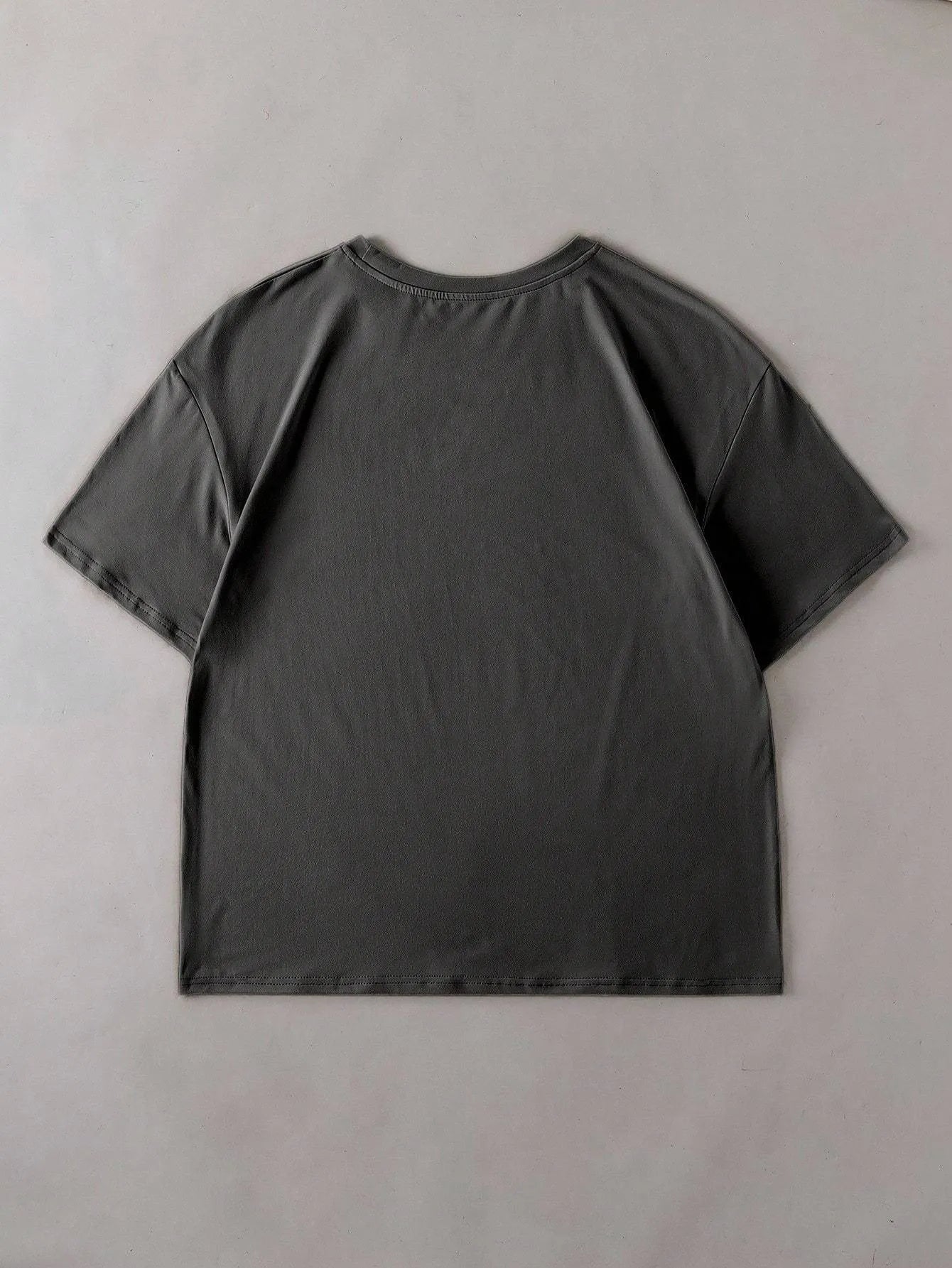 Loose fit cotton short sleeve T-shirt in black, green, grey, or orange on a hanger