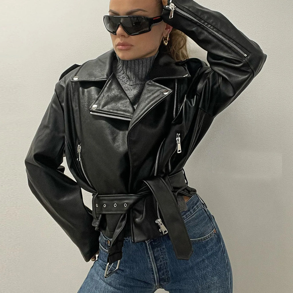 Black punk-style locomotive jacket with a drawstring waist, Peter Pan collar, and regular sleeves on a hanger.