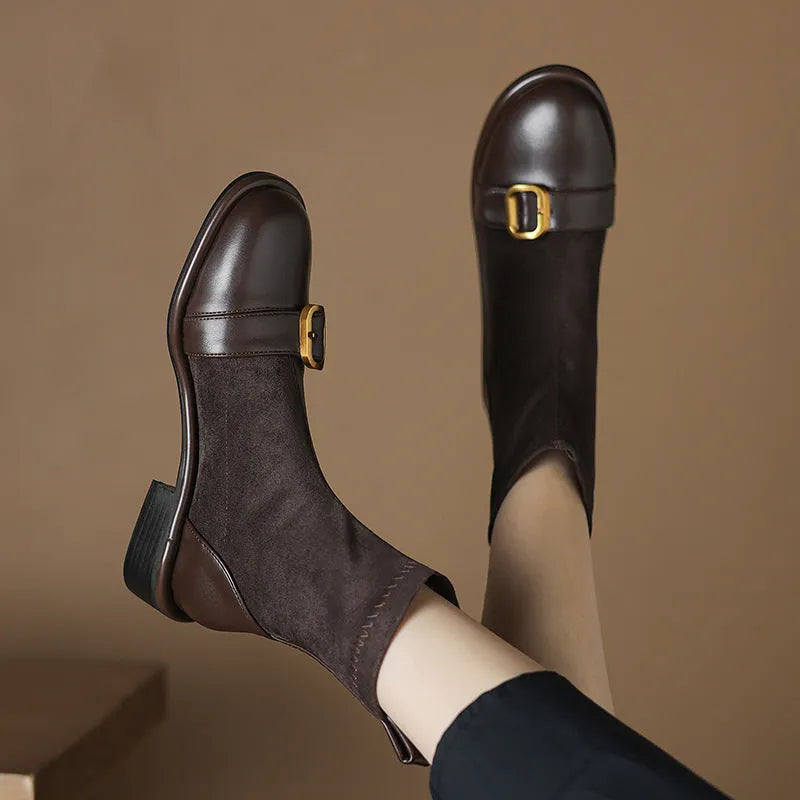 Women's black low-heel Martin ankle boots with front lace-up and belt buckle detail stitching.