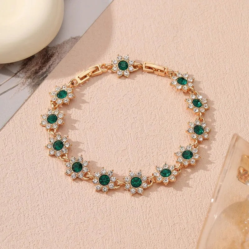 Electroplated zinc alloy flower bracelet in a choice of gold or silver finishes with coloured gemstone designs.