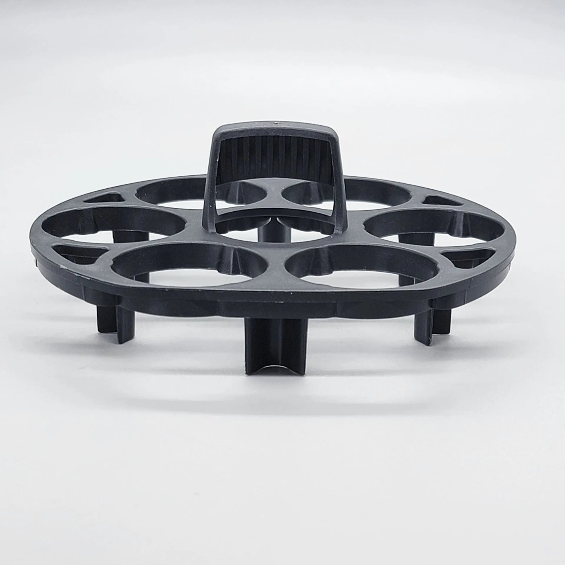 Black plastic egg holder cooking basket rack with modern design on a white background.