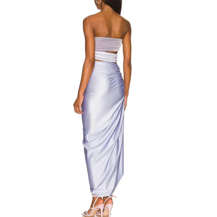 Purple one-piece swimsuit with hollow design and matching wrap skirt on white background