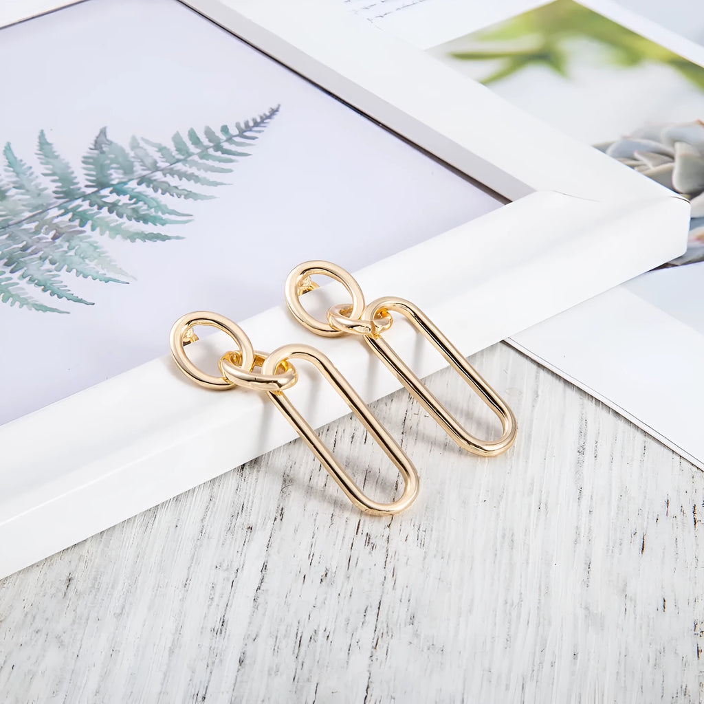 Geometric sterling silver needle hoop earrings with ring and line design in alloy metal