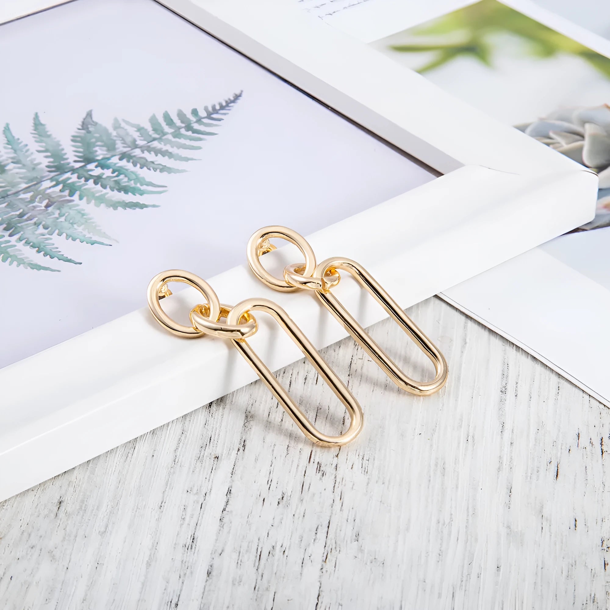 Geometric sterling silver needle hoop earrings with ring and line design in alloy metal