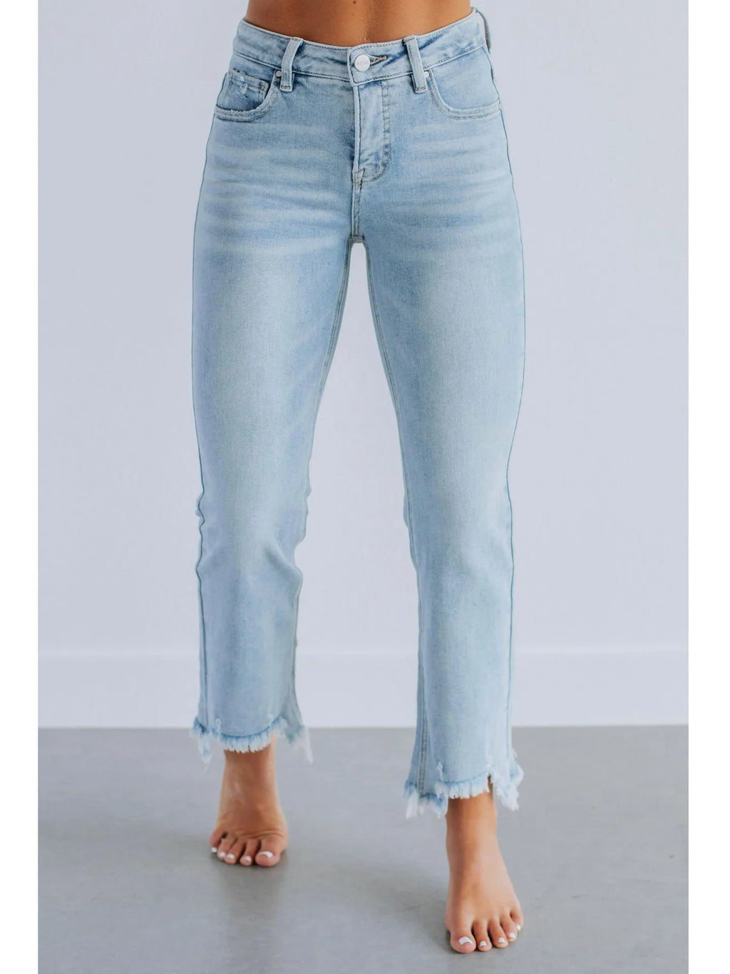 Women's solid colour denim jeans on a hanger showing hand-worn texture and available in dark blue and light blue