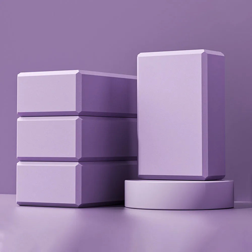 Solid colour high-density EVA foam yoga block with ridged sides on a gym mat