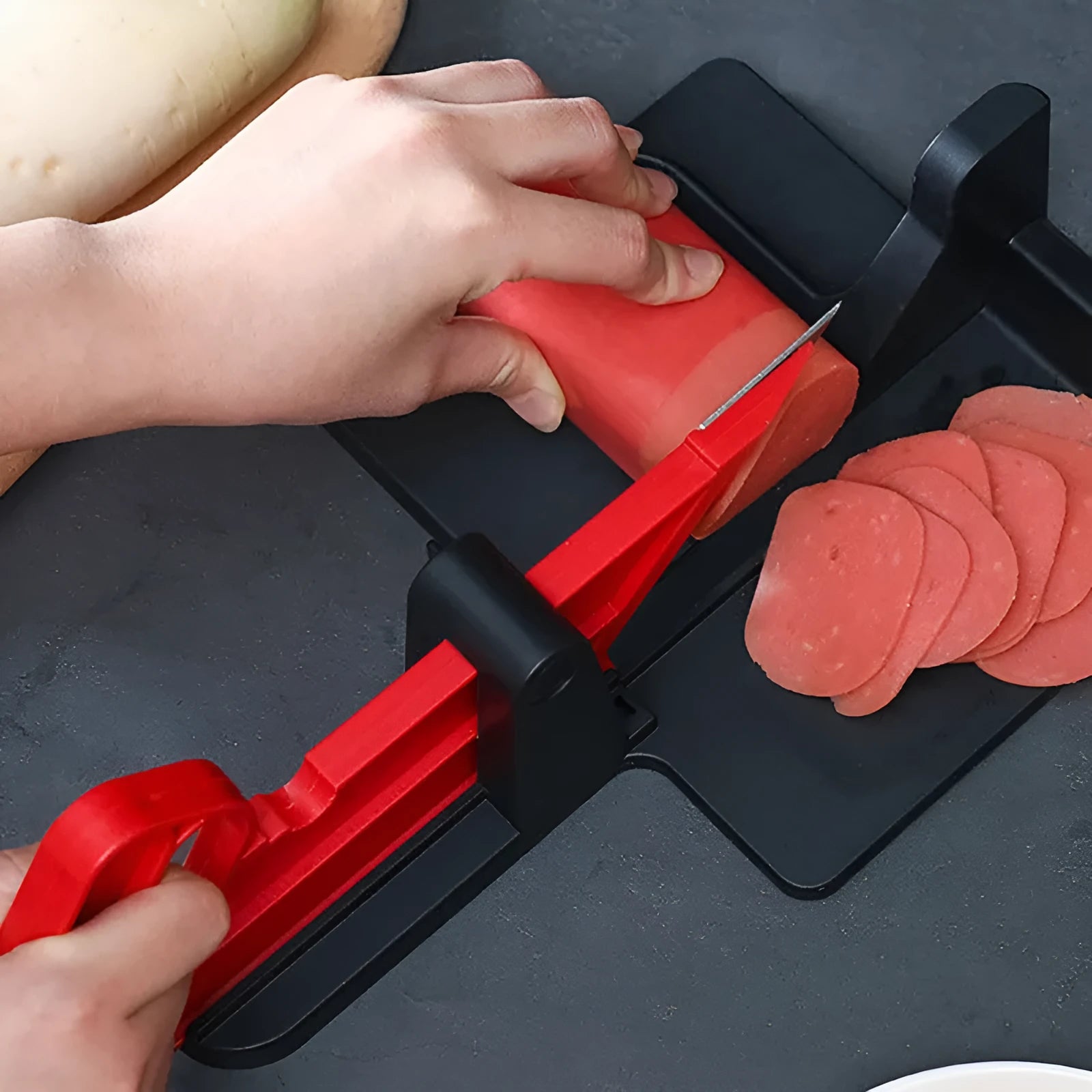 Green and red modern vegetable cutting tool for carrots and potatoes on a kitchen counter