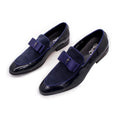 Men's black patent leather low-top shoes with a gold tassel detail and rubber sole.