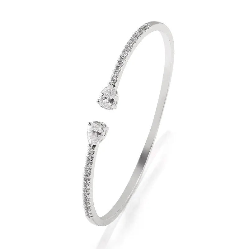 Copper bracelet with inlaid white zircon crystals on a simple band.