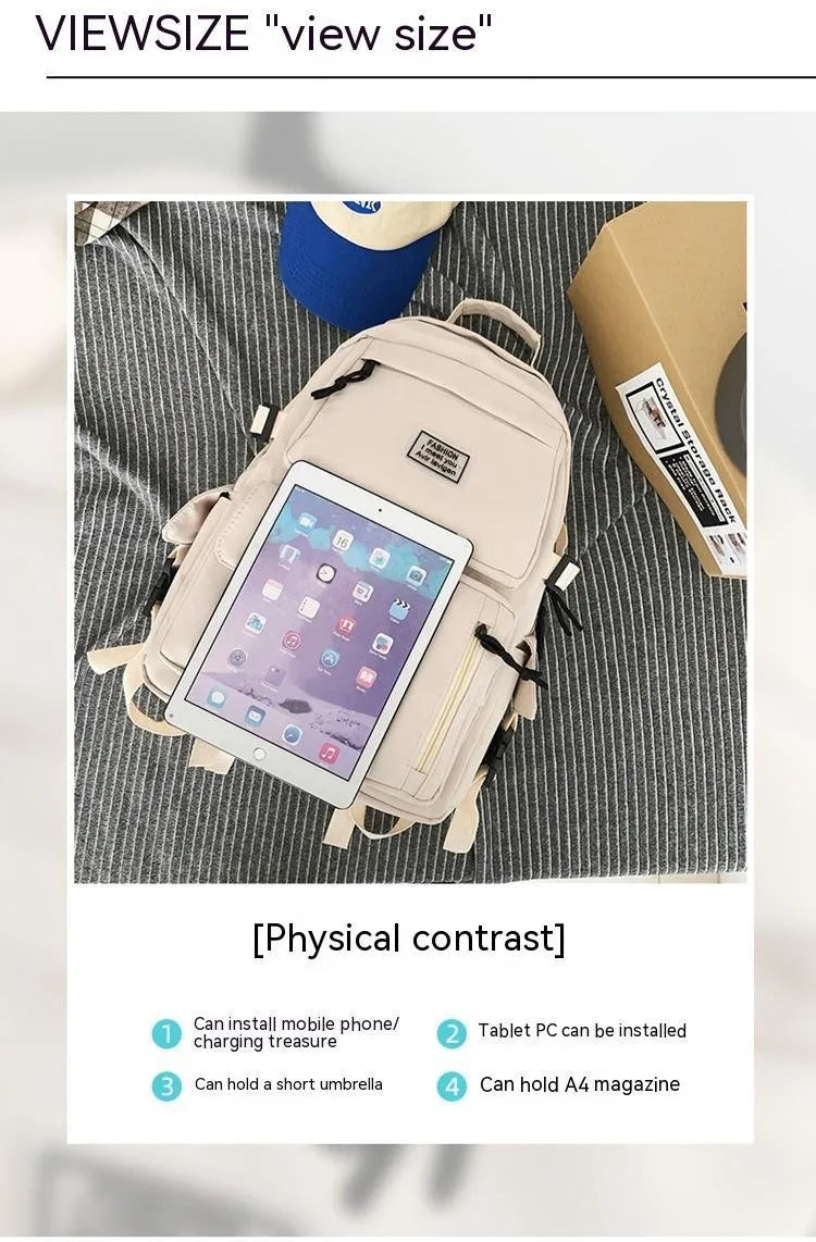 Black and white nylon student backpack with front 3D pockets, shown with laptop in compartment.