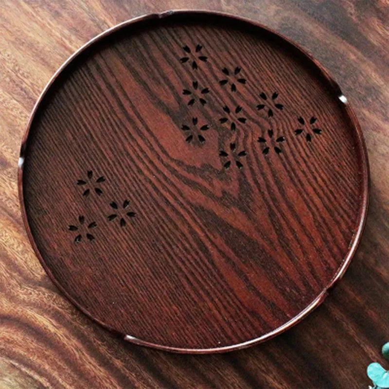 Wooden shallow serving plate with hollow cherry blossom design, 30 cm in diameter.