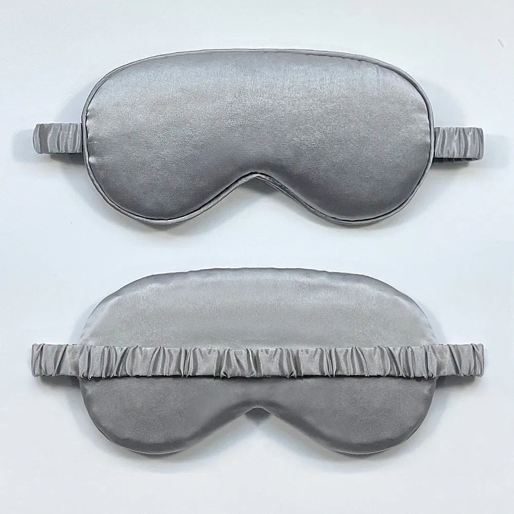Double-sided Rayon elastic satin sleep mask shown in multiple colour options including sky blue, black, wine red, and light pink.