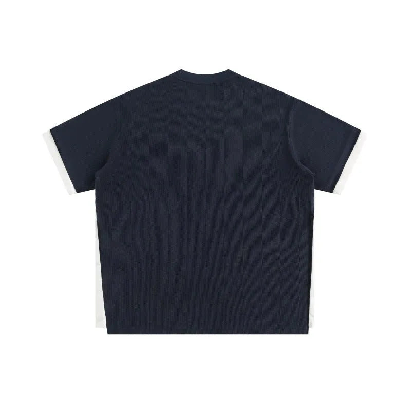Loose-fit short-sleeved T-shirt with embroidered retro alphabet design on waffle-textured fabric.