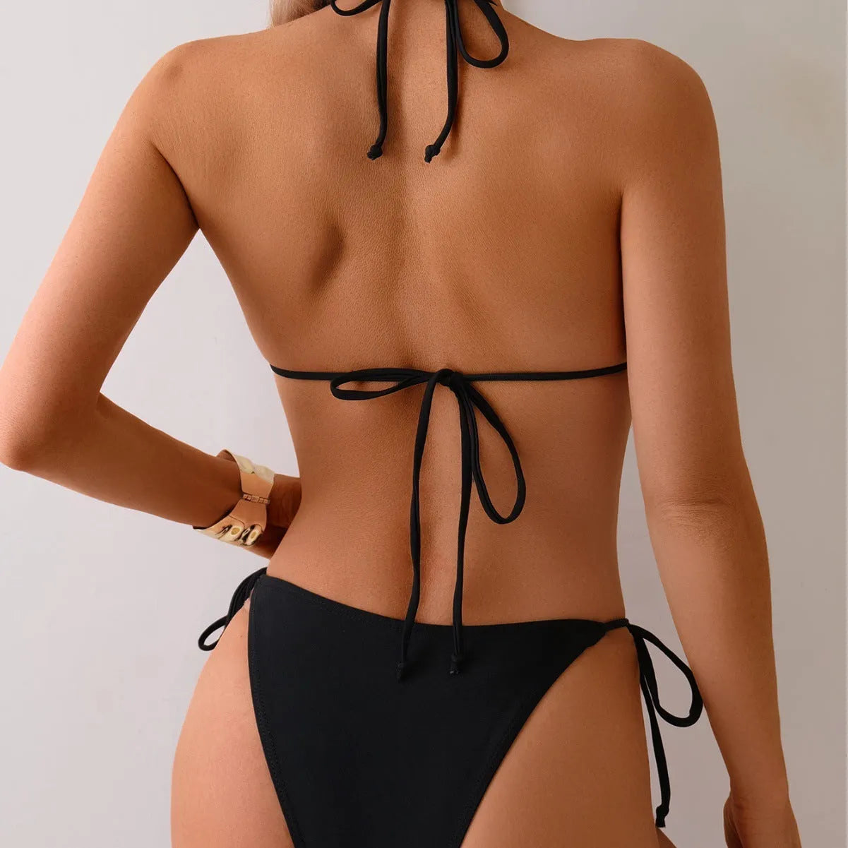 Black women's two-piece bikini swimsuit with a silver metal bead decorative detail on the front.