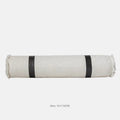 Grey and white plaid polyester bed runner blanket set with matching pillowcase and round leather-look cushion on a bed