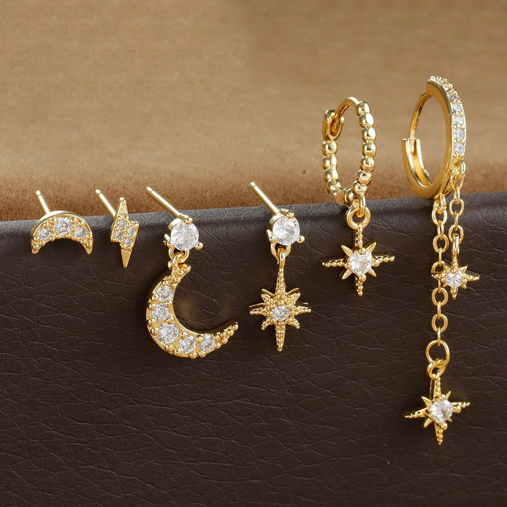 Set of six gold-coloured women's earrings with chain tassel designs and zircon studs on a white background.