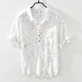 Men's loose fit short sleeve polo shirt in black, showing lapel collar and cardigan style