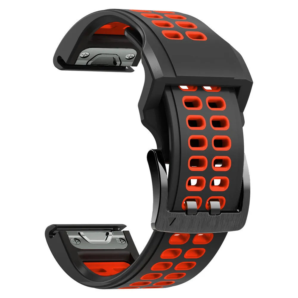 Close-up of a two-tone black and orange silicone watch strap with quick-release pins and a pin buckle.
