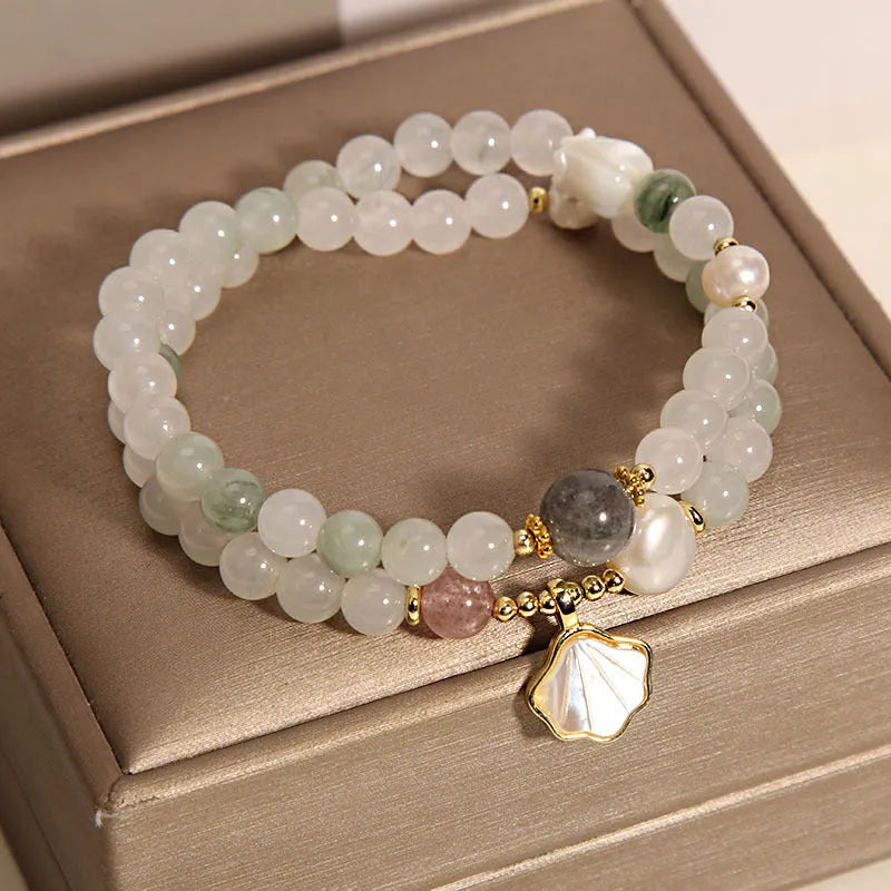 Women's crystal bracelet with an apricot leaf and jade shell pendant, gold-plated settings, and rhinestones.