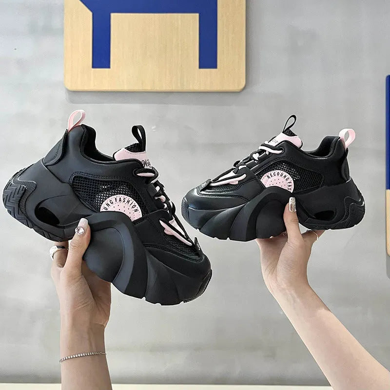 Women's pink casual sneakers with cross strap design and thick sole showing side profile