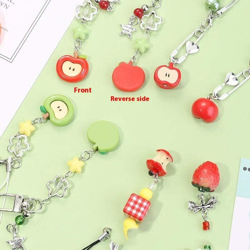 Plastic resin fruit charm keychain with removable rope in strawberry, green apple, and red apple designs.