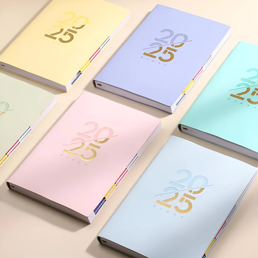 Soft faux leather A5 daily planner book open on a desk, showing Dorian paper pages and available colour variants.