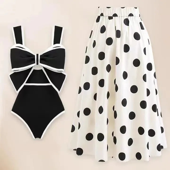 Female one-piece swimsuit with round skirt and bow detail in black or white polyester fabric for swimming and beach wear