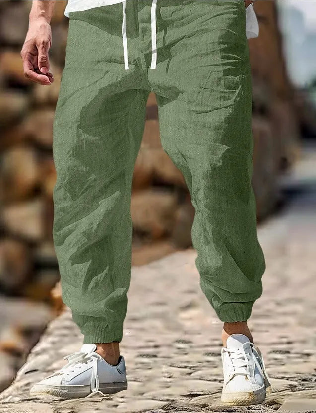 Men's straight-leg linen trousers in apricot colour with an elasticated waistband.