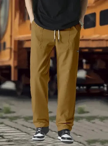 Men's straight-leg lightweight polyester trousers in light grey colour, laid flat showing front design