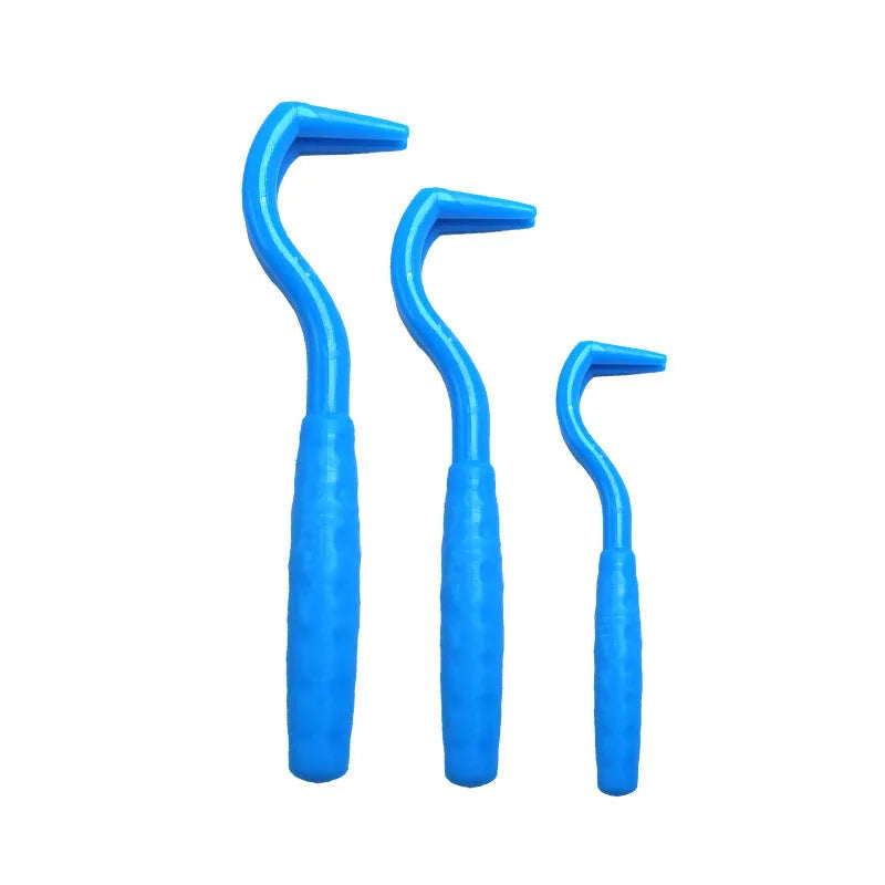 Set of three coloured plastic tick removal hooks for pets on a white background.