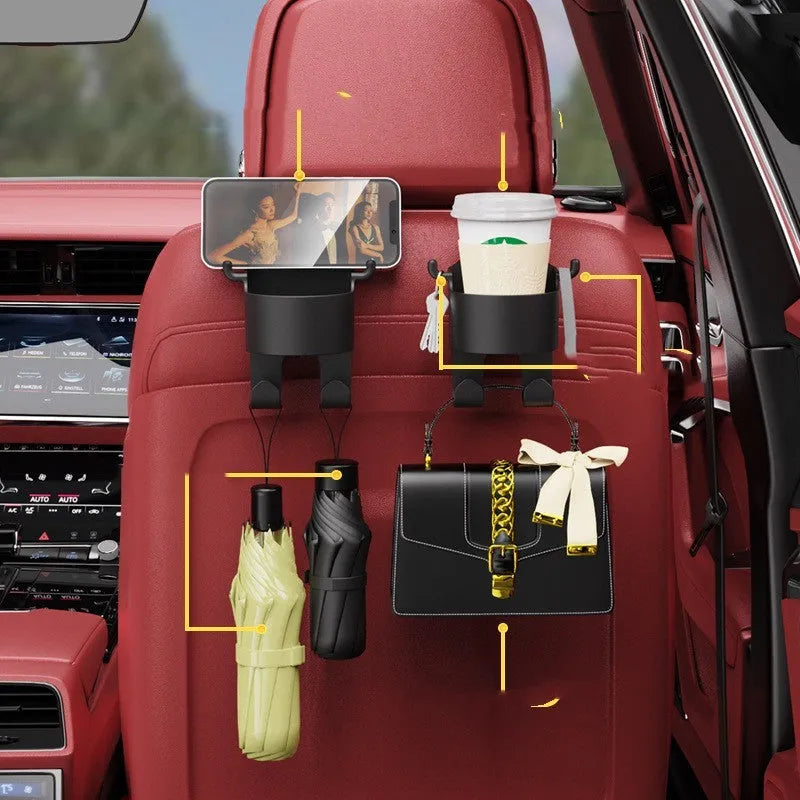 Black plastic car seat back organiser with cup holder and hanging hooks mounted on vehicle headrest