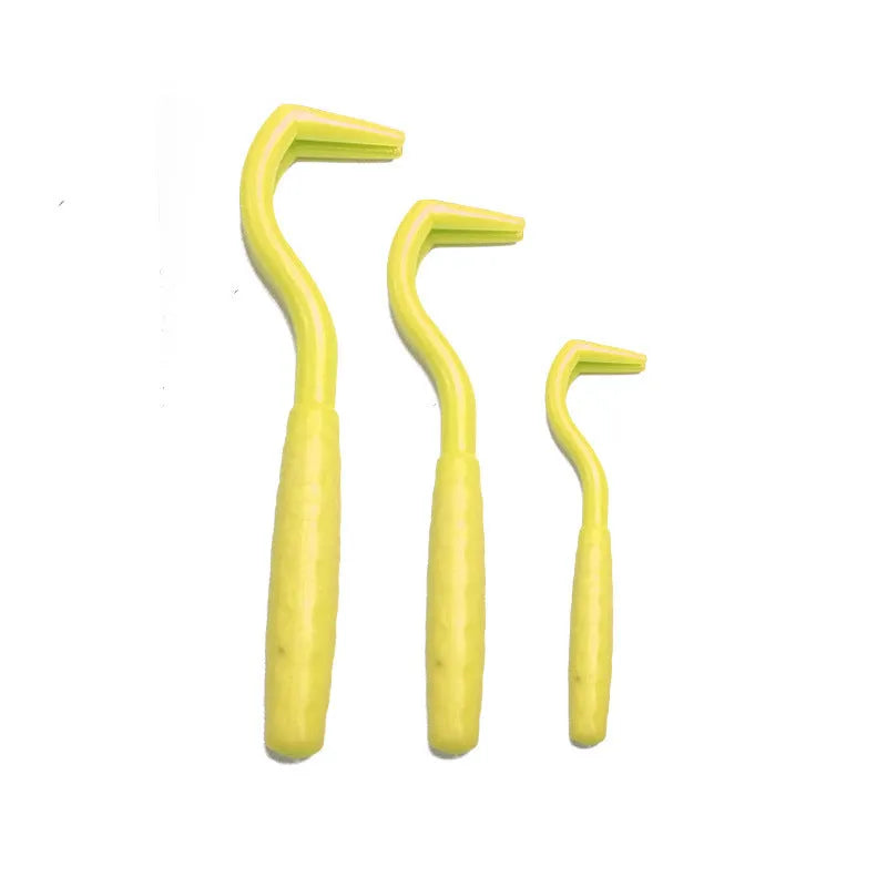 Set of three coloured plastic tick removal hooks for pets on a white background.